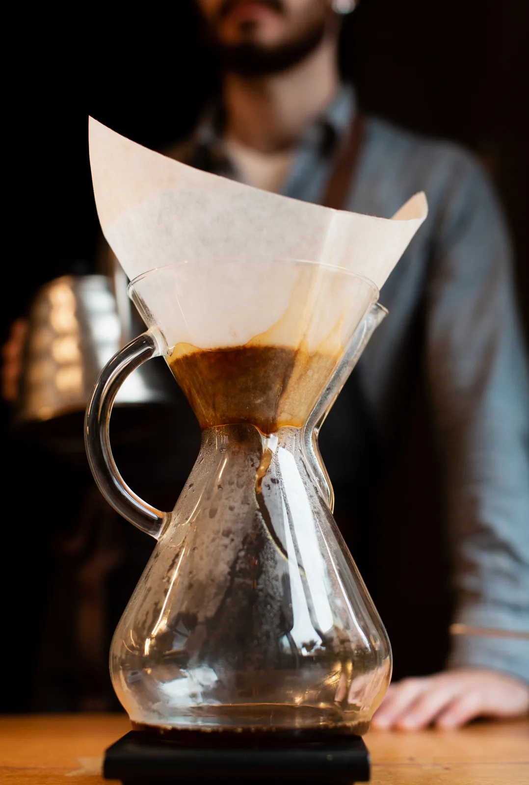 A barista pouring a slow pour-over at Amro Café