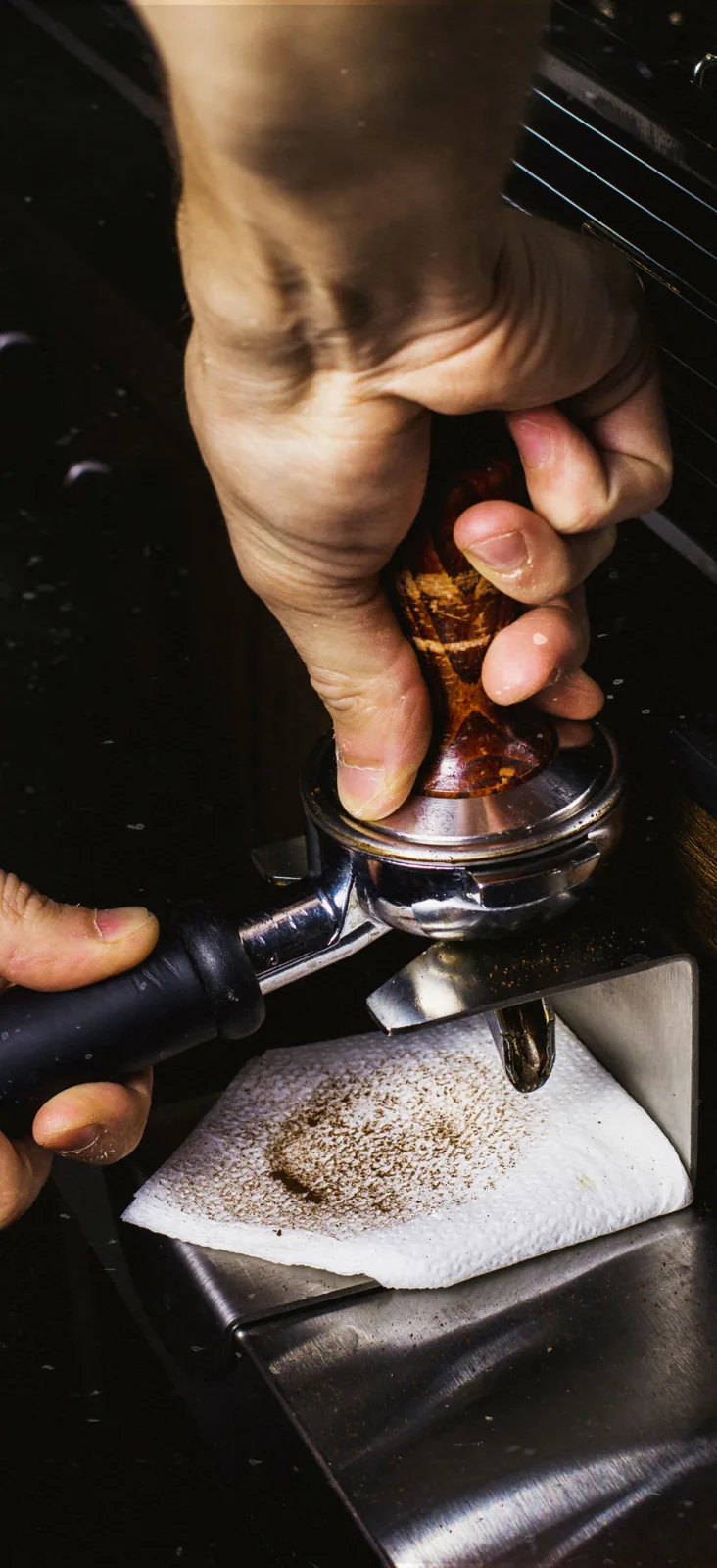 Pressing freshly ground coffee